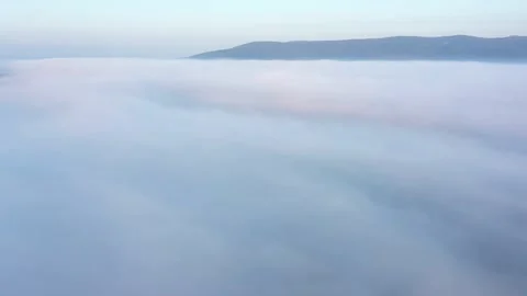 Dawn aerial view above clouds unveiling mountain ridge Видео 281120919