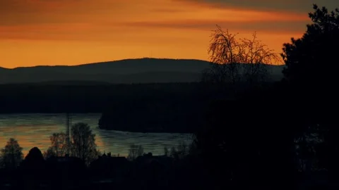 Dawn after sunset over a lake in Falun, Dalarna. Blue - orange image. 스톡 동영상 245229841