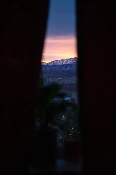 Dawn on the background of mountains. view from the window Stock Photos