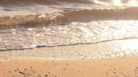 Dawn Beach Scene - Sunlit Shallow Waves Wash on Golden Sand 4K Nature Background Stock Footage 108449299