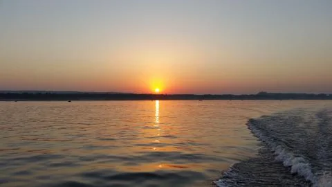 Dawn on the boat while driving the spray from the motor Stock Photos