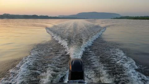 Dawn on the boat while driving the spray from the motor Stock Photos