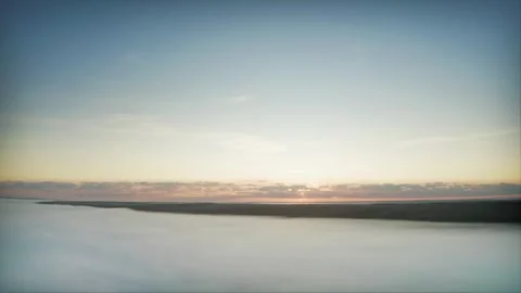 Dawn Breaks Through a Misty River: Early Summer Morning Enveloped in Fog. Aerial Stock Footage 257770703