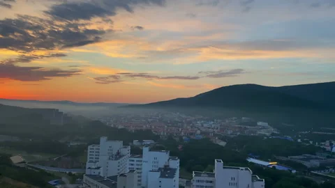 Dawn in a cozy place that is located in the middle of the mountains. Stock Footage 156801893