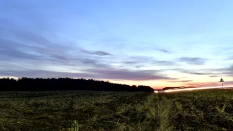 Dawn: fast traffic, view of the road. Moving clouds in the sky Stock Footage 141607421