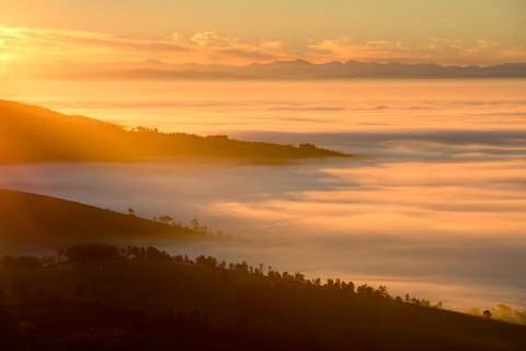 Dawn on fields and forests wrapped in mist Stock Photos