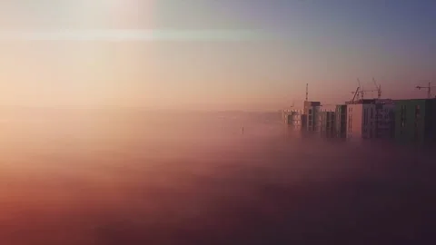 Dawn flight over the field and houses morning fog Stock Footage 130648902