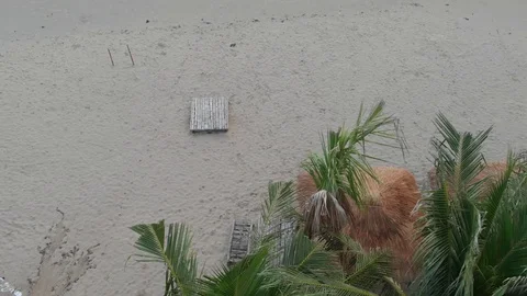 At dawn the flying camera flies beautifully over the beach overlooking the sea Stock Footage 100190390