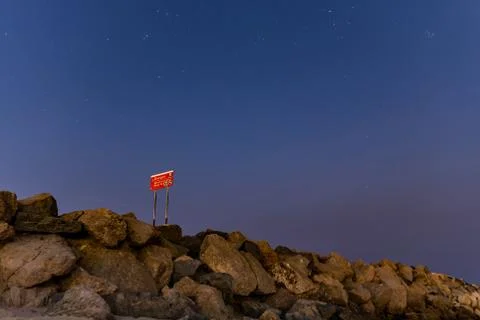 Dawn has yet to break over coastal beach. Stock Photos