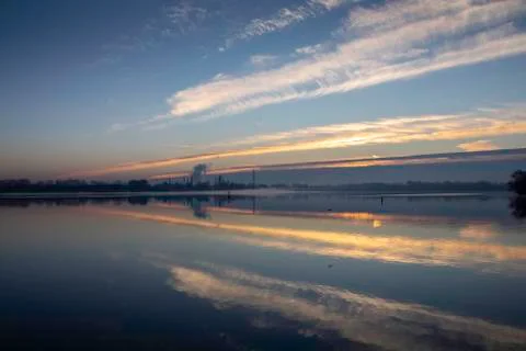Dawn on a lake with industrial background 스톡 사진