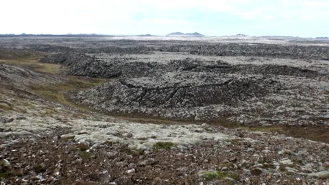 At Dawn, Lava Field Stretches to Distant Mountains in Iceland Video stock 321062913