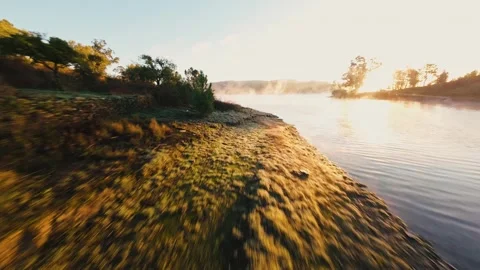Dawn light glows over calm lake surface at Castelo de Bode Stock Footage 342269422