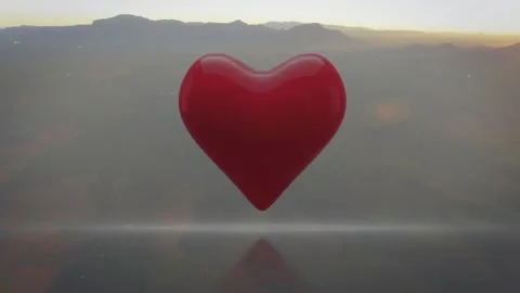 Dawn light hitting glossy red 3D heart, elongating, enlarging, revealing Stock Footage 330427705