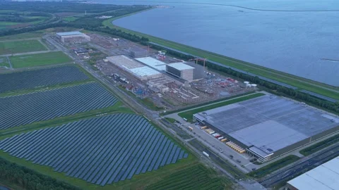 Dawn light over distribution center build, cranes and solar rows, Netherlands Stock Footage 315655592