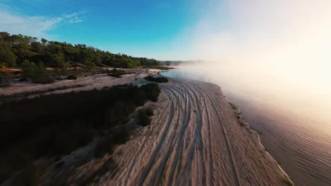 Dawn mist curls along rugged coastal cliffs Stock Footage 340903825