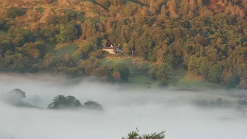 Dawn mist looking towards Black Fell, Lake District, UK. 스톡 동영상 240707703