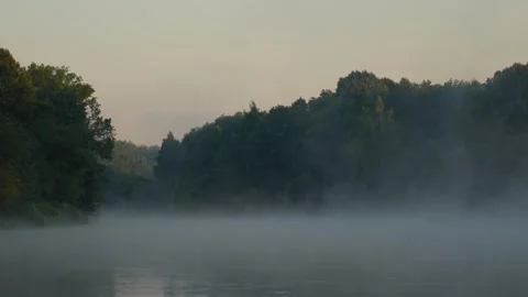 Dawn mist wraps calm lake waters Stock Footage 342397401