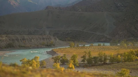 Dawn in the mountains. Mountain river and the sun's rays Stock Footage 102436653
