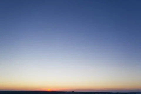 Dawn or sunset over the clouds, blue hour, aerial view. Stock Photos