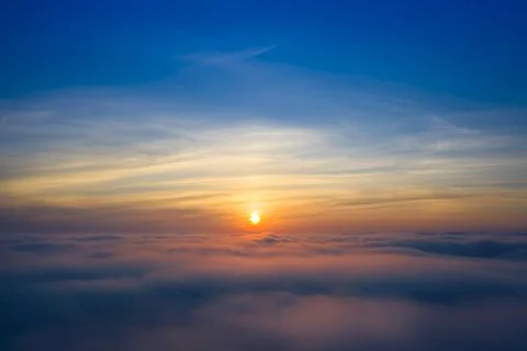 Dawn or sunset over the clouds, blue hour, aerial view. Stock Photos