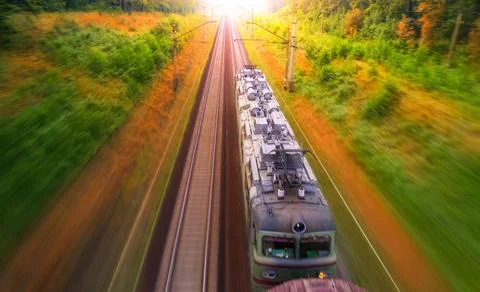 Dawn over the forest through which the railway line runs. Stock Photos
