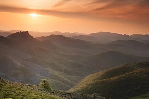 Dawn over the mountains with clouds Stock Photos