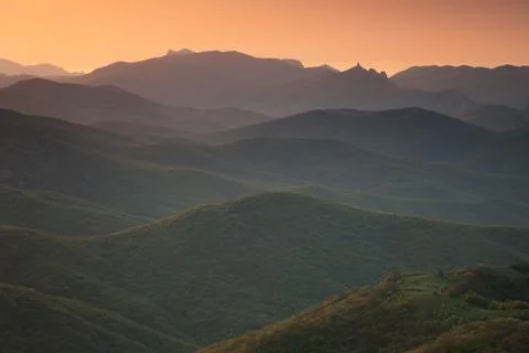 Dawn over the mountains with clouds Stock Photos