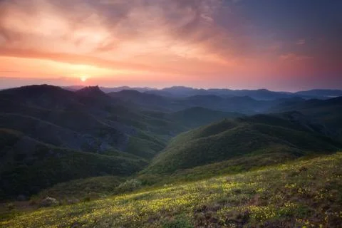 Dawn over the mountains with clouds Stock Photos