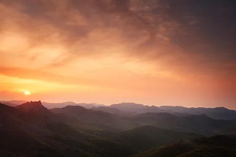 Dawn over the mountains with clouds. Stock Photos