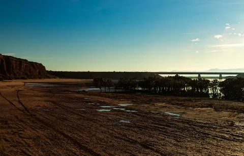Dawn Over Tidal Mudflat,Cliffs, and Bridge Stock Photos