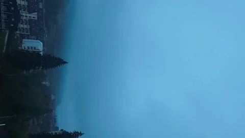 Dawn over a town in the mountains, the clouds are clearing. Time lapse Stock Footage 251468932
