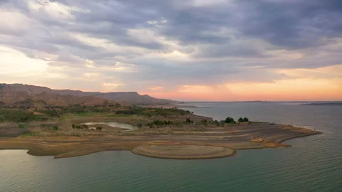 Dawn on the peninsula, the sun rises under variable cloudiness Stock Footage 310666394
