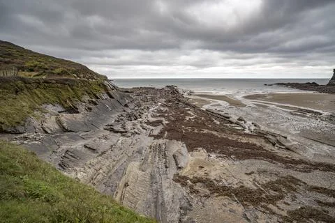 Dawn rain clouds hovering over Crackington Haven beach Stock Photos