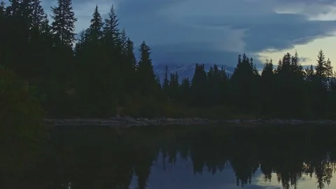 Dawn reflection of Mt. Hood covered in clouds on Mirror Lake in the fall forest Stock Footage 81619731