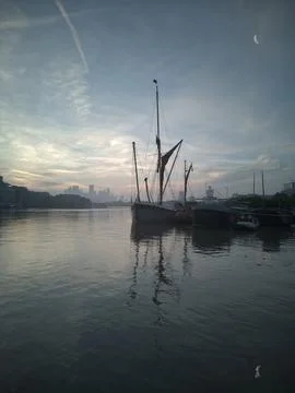 Dawn, River Thames (2). Sailing barge, London docklands behind. 9x16 Stock Photos