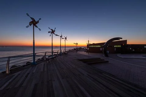 Dawn of the Sea with a Windmill Stock Photos