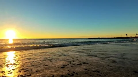 Dawn on the seashore looking at the pier Stock Footage 313634325