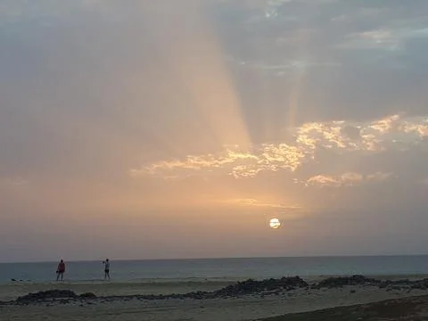 Dawn Sun Rays On Beach 4 Stock Photos