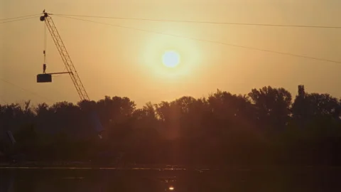 Dawn Sun Rises Over trees Growing on the Banks of the River of water ski park Stock Footage 159363049