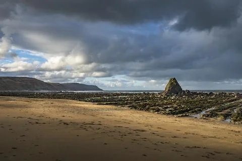Dawn sunlight breaking through the clouds at Widemouth Bay Cornwall Fotos Stock