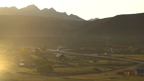 Dawn, a village in the mountain valley, the sun's rays, early morning Stock Footage