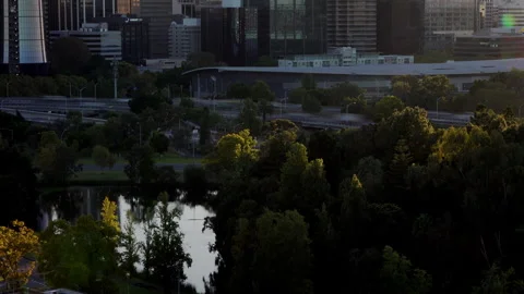 Dawn vista over Perth. Speeding traffic and crystal clear pond in foreground Video stock 242839824