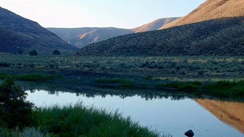 Dawn water reflection hills John Day River Cottonwood Canyon Oregon 07 Stock Footage 81991699