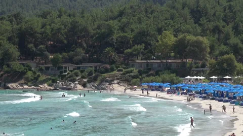 A day at the beach, waves, people, sunbeds and sun umbrellas, sea water, resort Stock Footage 35069891