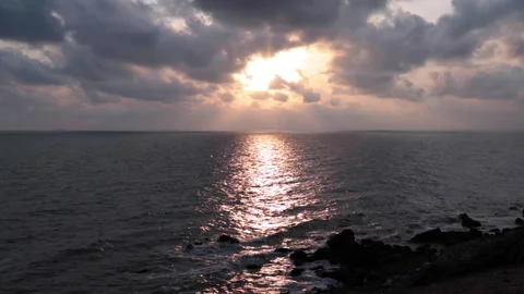 As the day begins its soft descent, the heavens part to reveal a celestial 動画素材 334180163