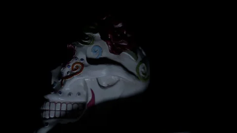 Day of the dead skull turns to face us in the dark Stock Footage 114086924