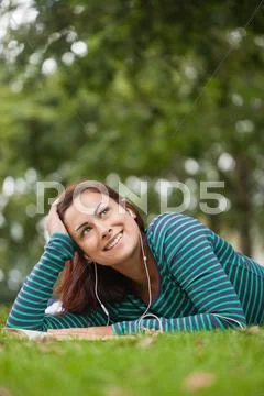 Day Dreaming Casual Student Lying On Grass Looking Up