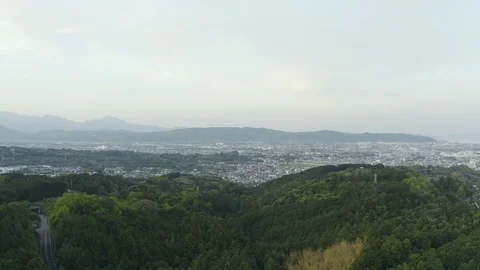 Day flight on a copter to the forest in the direction of the city filmed inJapan Stock Footage 110701713