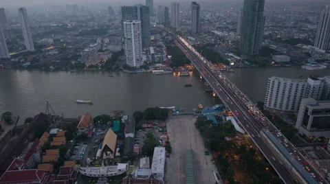 Day to night 4k timelapse of modern building at riverside with traffic on bridge Stock Footage 44519751