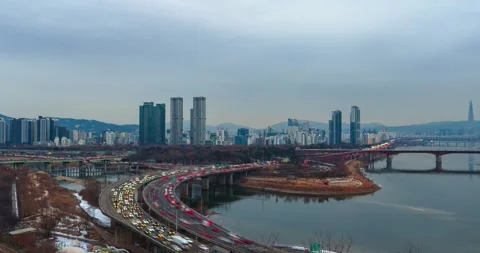Day to Night Hyperlapse Zoom Out of Seoul Skyline with Gangbyeonbuk-ro Stock Footage 330973553